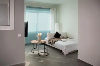 a bedroom with a bed with a table and a window at Kolymvari Hills in Chania Town