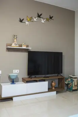 a living room with a flat screen tv and birds on the wall at Zoe's Place - 2 BD Beachfront Apartment in Kissamos