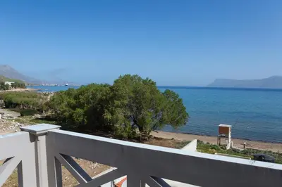 a view of the ocean from the balcony of a house at Zoe's Place - 2 BD Beachfront Apartment in Kissamos