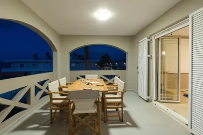 a dining room with a table and chairs at Zoe's Place - 2 BD Beachfront Apartment in Kissamos