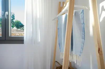 a couple of blue towels hanging in a room at Olive Apt - Akrotiri in Kounoupidhianá