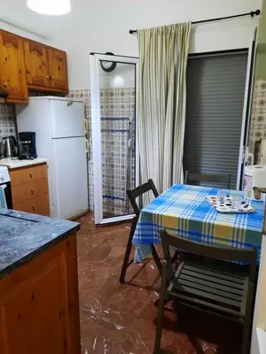 a kitchen with a table with a table cloth on it at Apartment Chania - Nea Chora in Chania Town