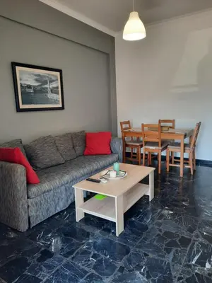 a living room with a couch and a table at Apartment Chania - Nea Chora in Chania Town