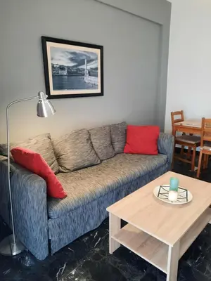 a living room with a couch and a table at Apartment Chania - Nea Chora in Chania Town