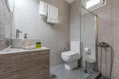 a bathroom with a toilet and a sink and a shower at VILLA APELLA - PRIVATE HEATED POOL in Nohia