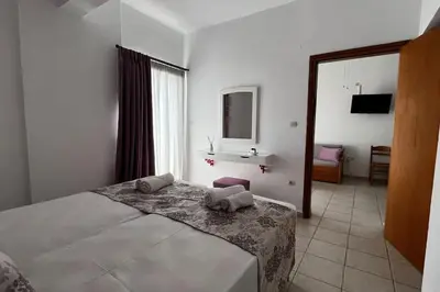 a bedroom with a bed with two pillows on it at Michael Apartments 2 in Agia Marina Nea Kydonias