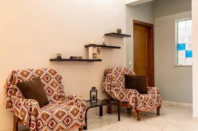 two chairs and a table in a room at Big spacious apartment in the heart of the city! in Chania Town