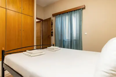 a bedroom with a bed and a large mirror at Big spacious apartment in the heart of the city! in Chania Town