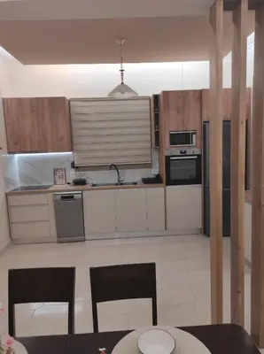 a kitchen with a table and two chairs in a room at TziApartment in downtown Chania in Chania Town