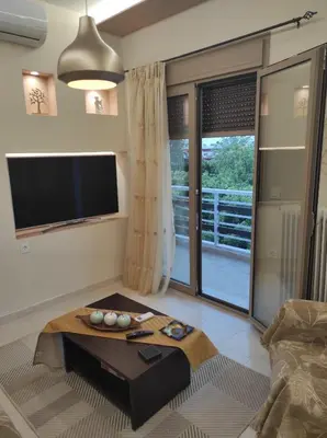 a living room with a tv and a coffee table at TziApartment in downtown Chania in Chania Town