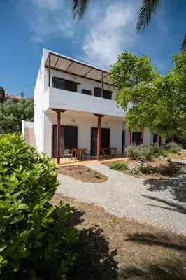 a white house with a table in front of it at MYLOS (6) in Chania Town