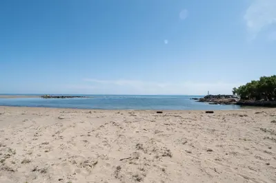 a sandy beach with the ocean in the background at MYLOS (6) in Chania Town
