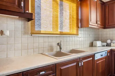 a kitchen with a sink and a window at Sunset Apartment in Platanias in Plataniás
