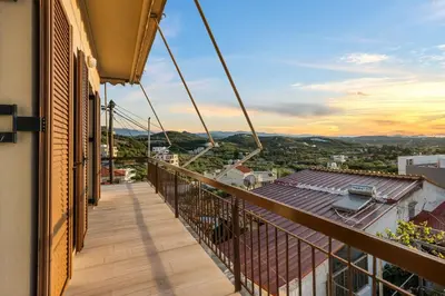 a balcony with a view of a city at Sunset Apartment in Platanias in Plataniás