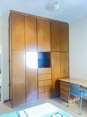 a large wooden cabinet with a desk and a tv at Sunset Apartment in Platanias in Plataniás