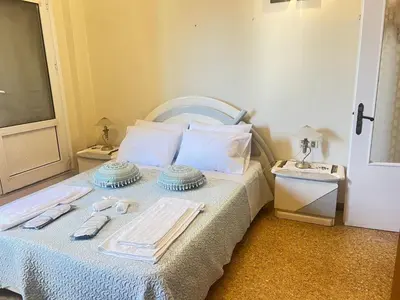 a bedroom with a bed with towels on it at Sunset Apartment in Platanias in Plataniás