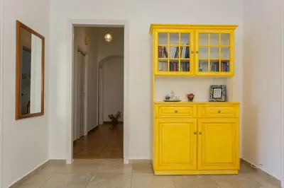 a yellow cabinet in a room with a hallway at House of joy close to Chania center in Chania Town