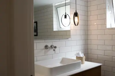 a white bathroom with a sink and a mirror at House of joy close to Chania center in Chania Town