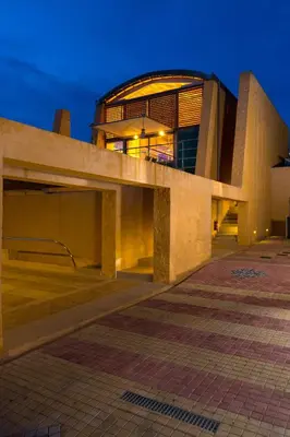 a building at night with its lights on at Eleni's Serenity - Discovering Sapphire Harmonies in Ravdhoúkha
