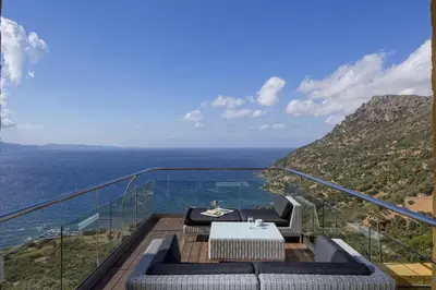 a view of the ocean from the balcony of a house at Eleni's Serenity - Discovering Sapphire Harmonies in Ravdhoúkha