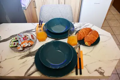 a table with two plates of food and orange juice at Relaxed Dream home in Chania Town