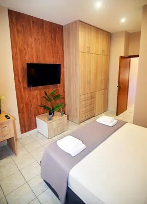 a bedroom with a large bed and a tv at Relaxed Dream home in Chania Town