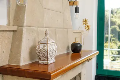a table with a vase and an apple on it at Villa Giannari in Stalos