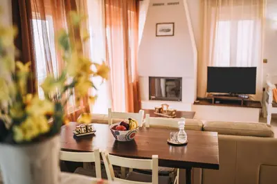 a living room with a table with a bowl of fruit on it at Aptera Dream Apartment in Áptera