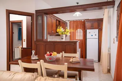 a kitchen with a table with a bowl of fruit on it at Aptera Dream Apartment in Áptera