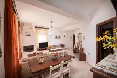 a living room with a couch and a table at Aptera Dream Apartment in Áptera