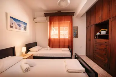 a bedroom with two beds and a window at Aptera Dream Apartment in Áptera