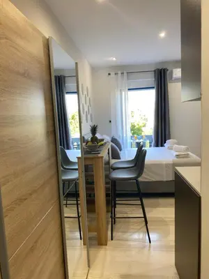 a room with a bed and a table and chairs at Rouan Studios in Souda