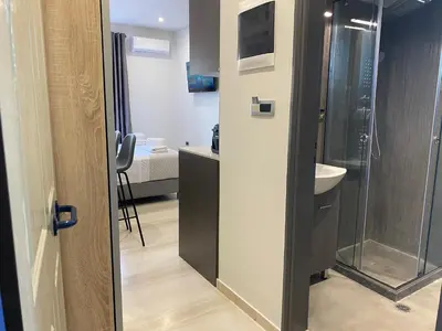 a bathroom with a shower and a sink at Rouan Studios in Souda
