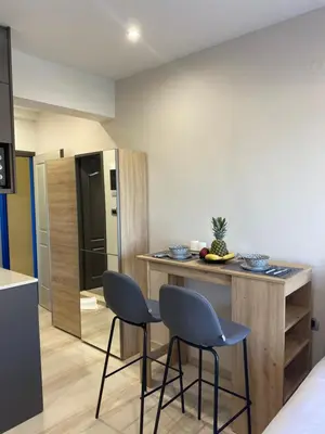 a kitchen with two chairs and a island in a room at Rouan Studios in Souda