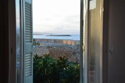 an open window with a view of the ocean at Para thin alós House in Chania Town