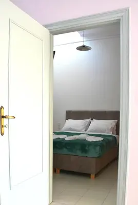 a bedroom with a bed with a door open at Para thin alós House in Chania Town