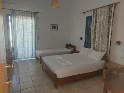 a bedroom with two beds in a room at Lissos Studios - Rooms in Palaiochóra
