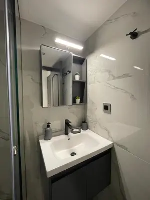 a bathroom with a sink and a mirror at Rouan studios 1 in Souda