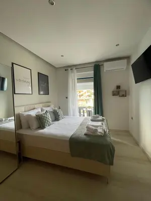 a bedroom with a large bed and a window at Rouan studios 1 in Souda
