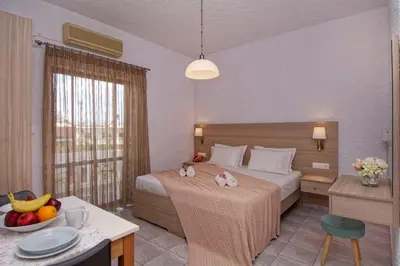 a hotel room with a bed and a table with fruit on it at Studios George in Palaiochóra