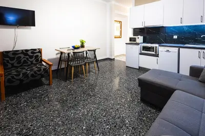 a kitchen and living room with a couch and a table at Kaliopi's Apartments in Chania Town