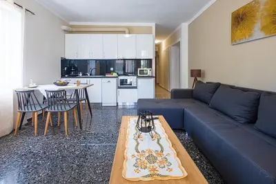 a living room with a blue couch and a table at Kaliopi's Apartments in Chania Town