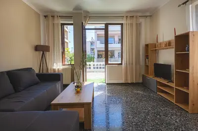 a living room with a couch and a tv at Kaliopi's Apartments in Chania Town