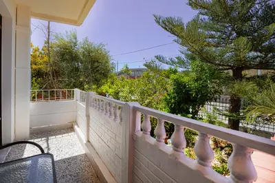 a balcony with a white fence and a tree at Kaliopi's Apartments in Chania Town