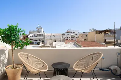 a patio with chairs and a tree on a balcony at Casa Di Sabbia in Chania Town