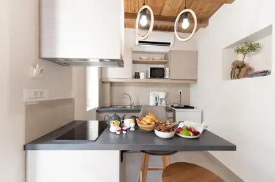 a kitchen with a counter with bowls of food on it at Casa Di Sabbia in Chania Town