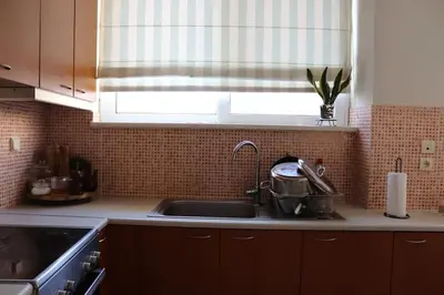 a kitchen counter with a sink and a window at Upper Side Koum-Kapi in Chania Town