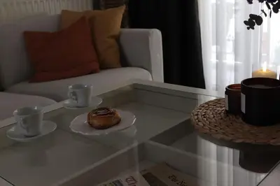 a coffee table with a donut on a plate on it at Upper Side Koum-Kapi in Chania Town