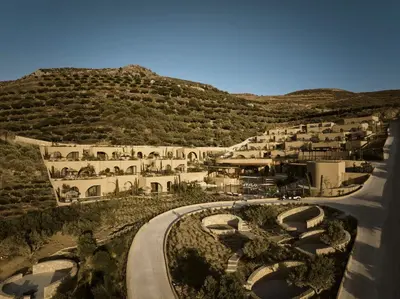arial view of a resort with a mountain at Tella Thera, a Member of Design Hotels in Kissamos