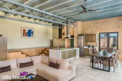 a living room and kitchen with a couch and a table at Elafonisi Villas in Livadia